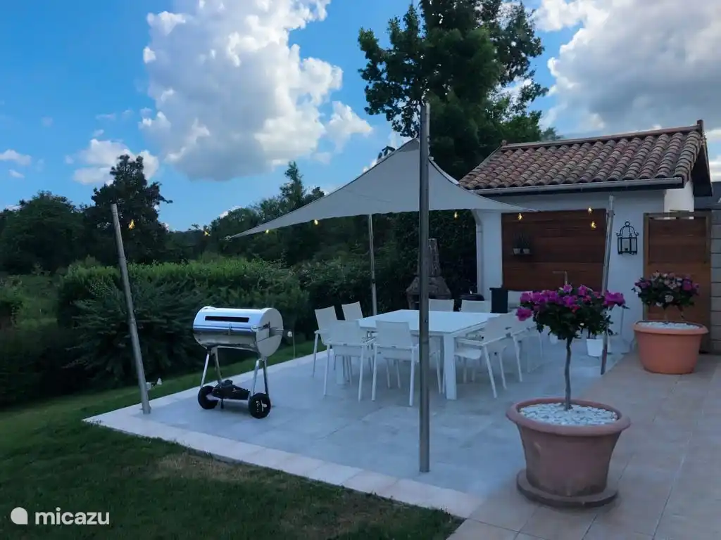Grande terrasse pour les longues soirées d'été avec cuisine extérieure, poêle à bois et BBQ. Avec de belles vues sur les collines de la Dordogne.