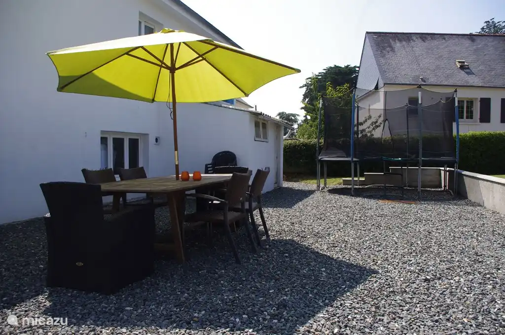 The parents on the terrace, the children on the trampoline
