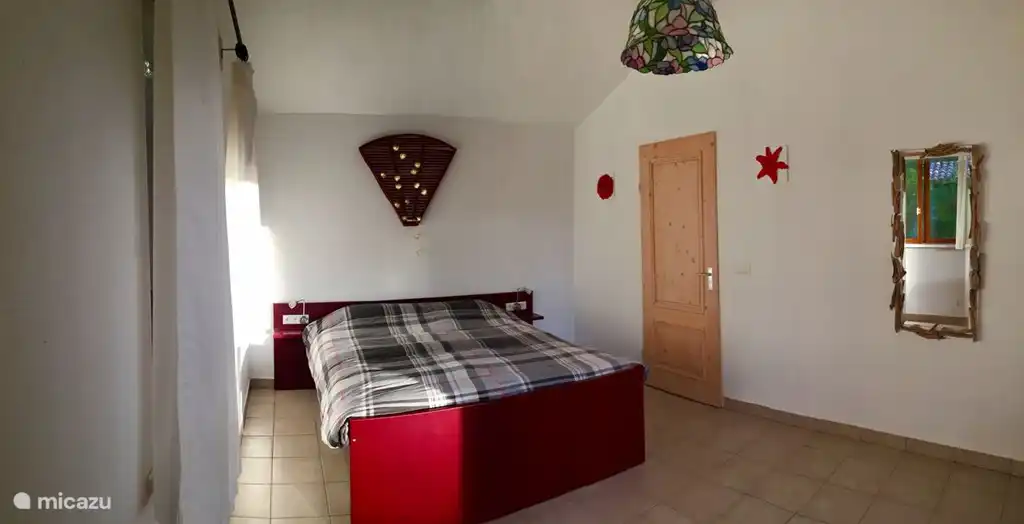 Rode slaapkamer in het Maison des Amis