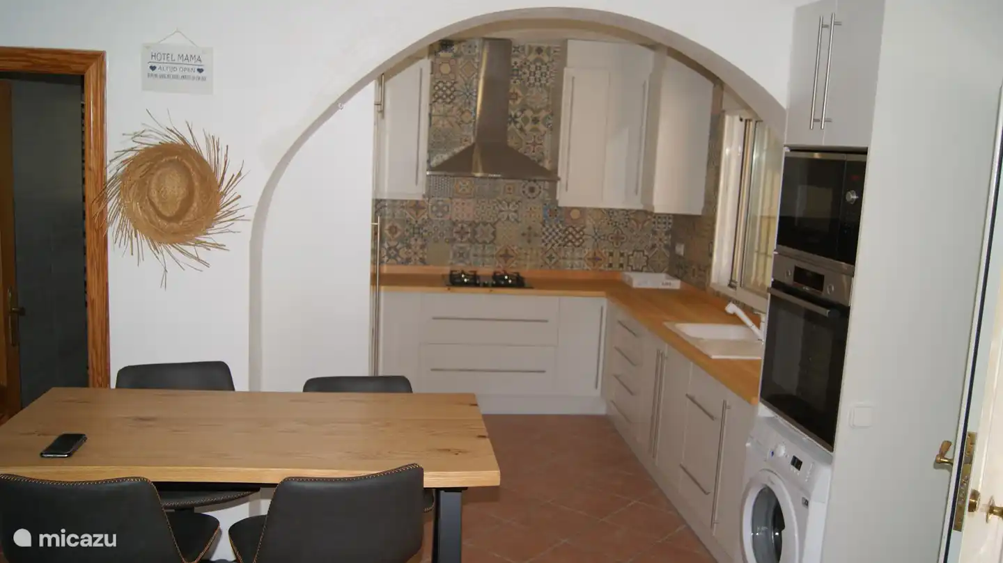 kitchen with oven, microwave, washing machine, gas stove