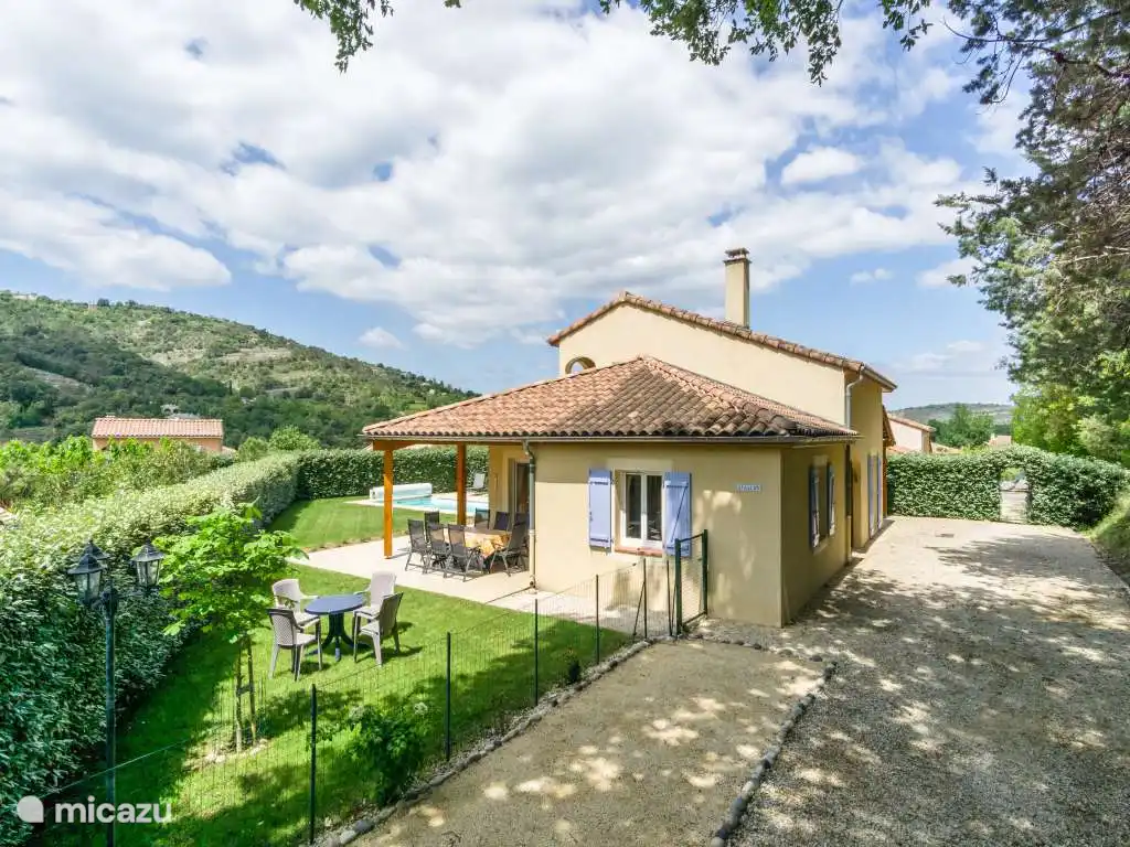 Vue d’ensemble de l’allée, du jardin, du terrain de pétanque et de la villa
