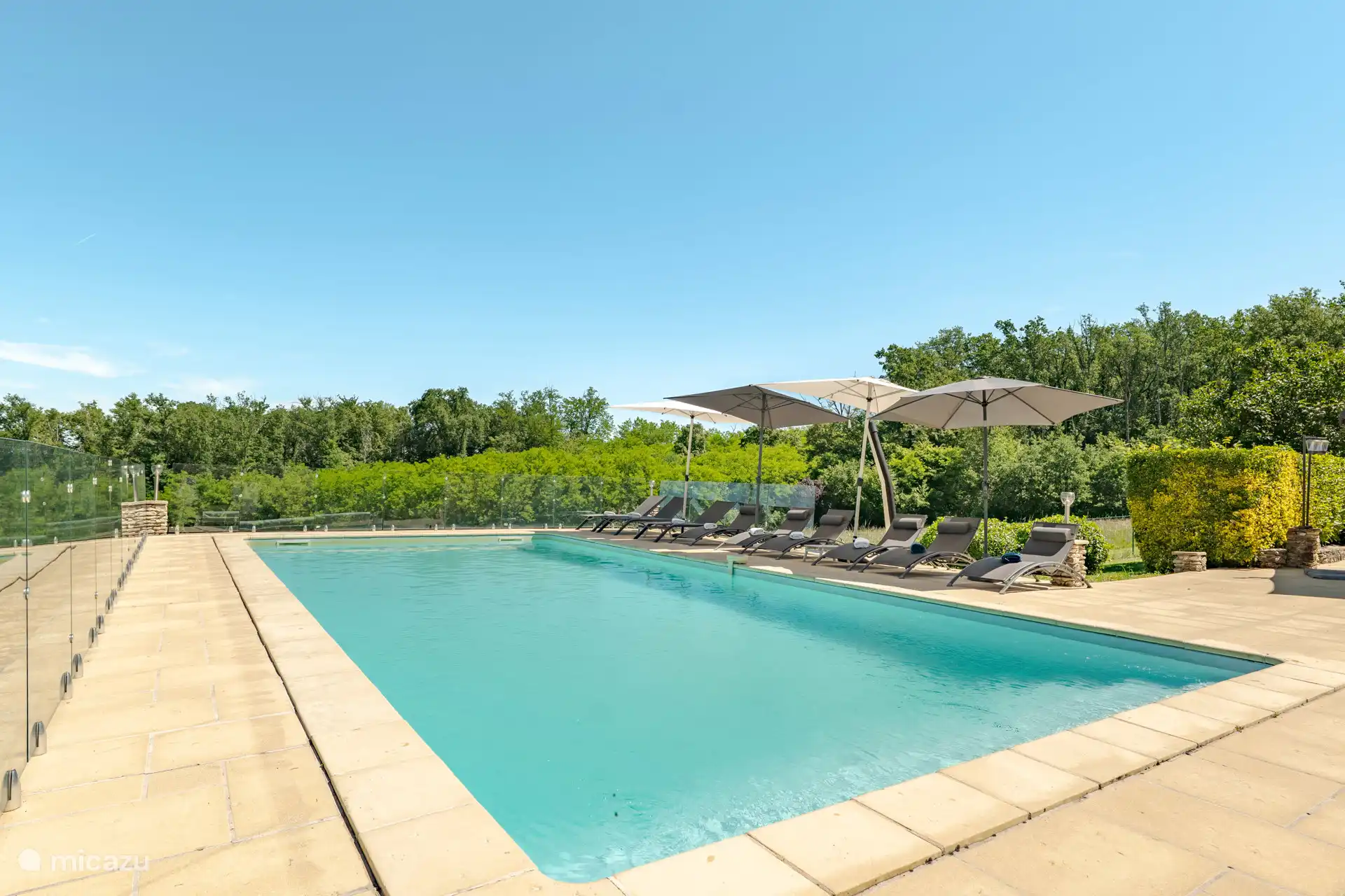 Swimming pool with sun loungers and parasols