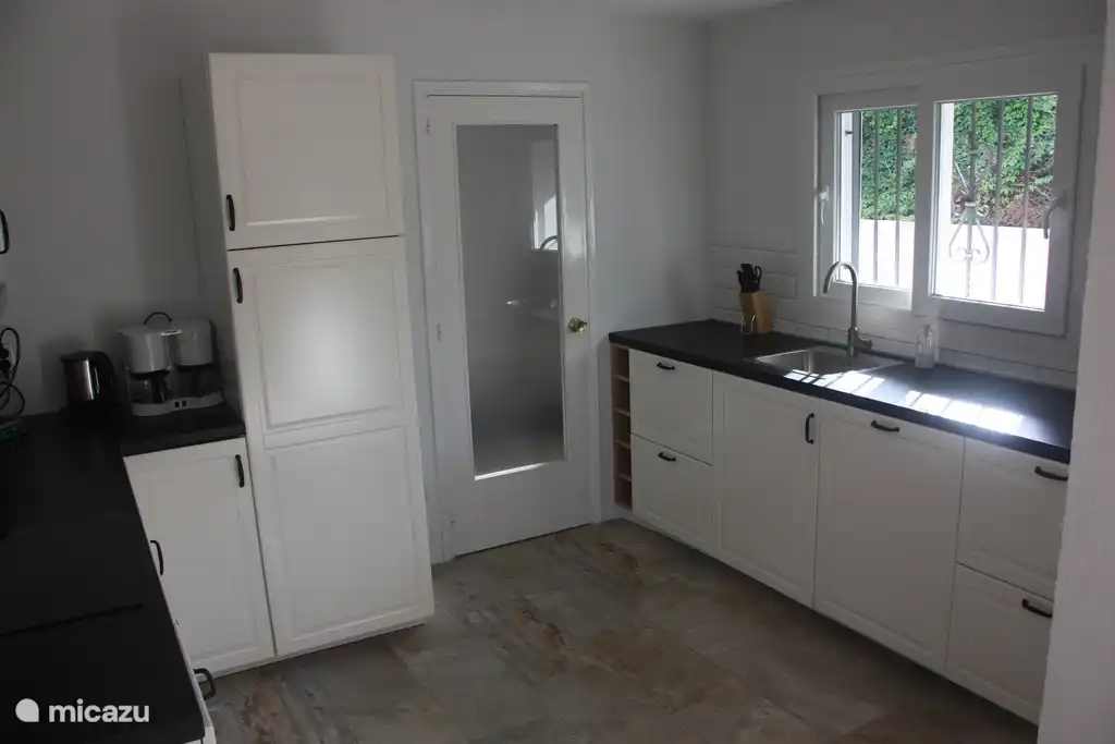 La cuisine spacieuse et moderne avec lave-vaisselle, 2 réfrigérateurs/congélateurs, plaques à induction, four et micro-ondes