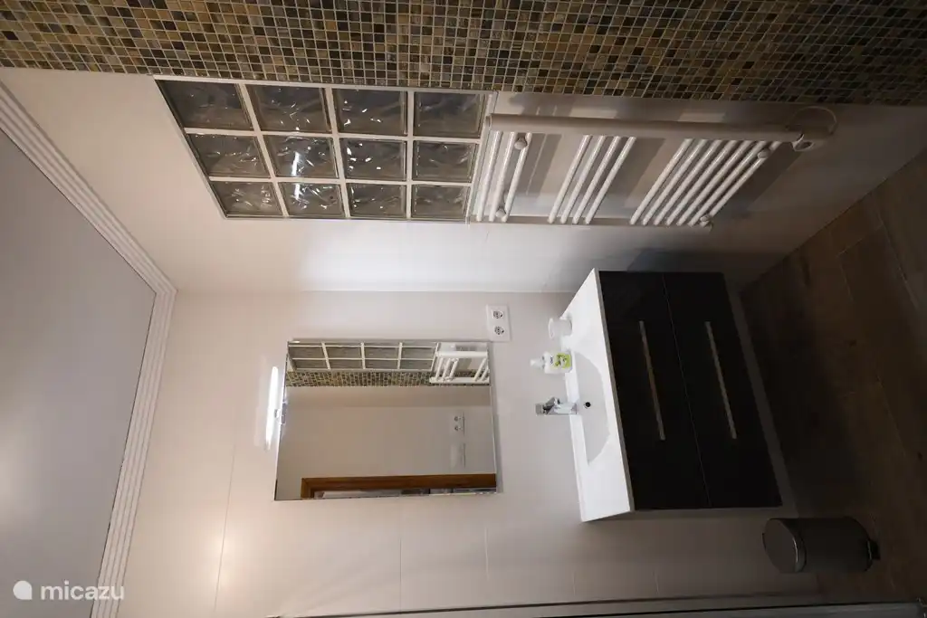 Sink with illuminated mirror where it is pleasantly heated in winter.