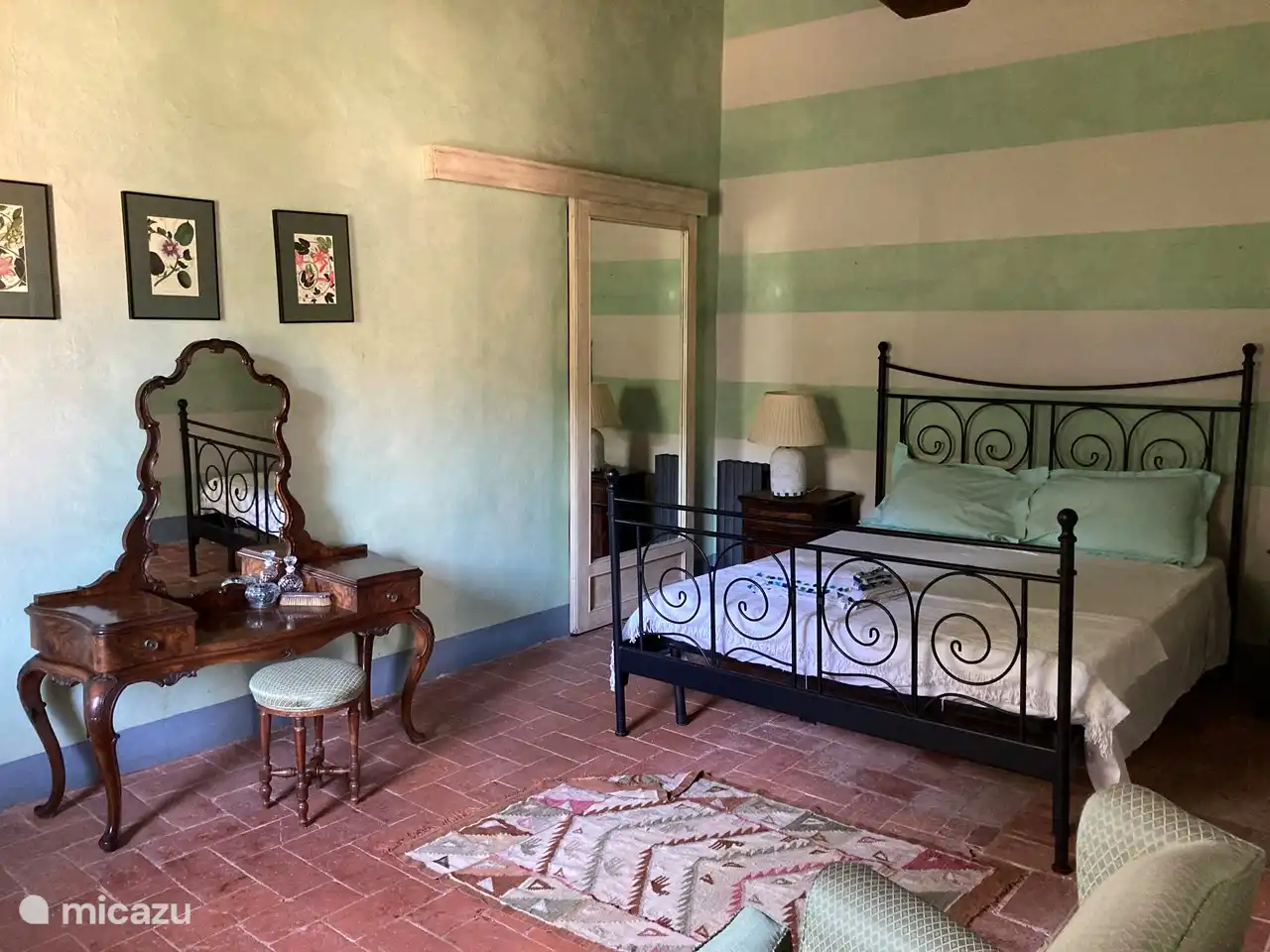 The green suite has a large double bed, walk-in wardrobe and ensuite bathroom, which is shared with the adjacent, small bedroom.