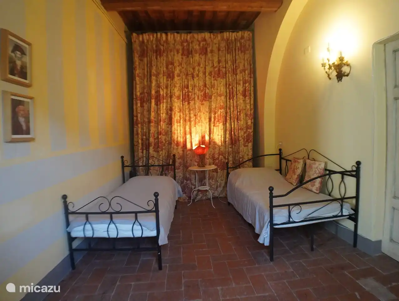 The beige twin bedroom shares the bathroom with the adjacent, double room.