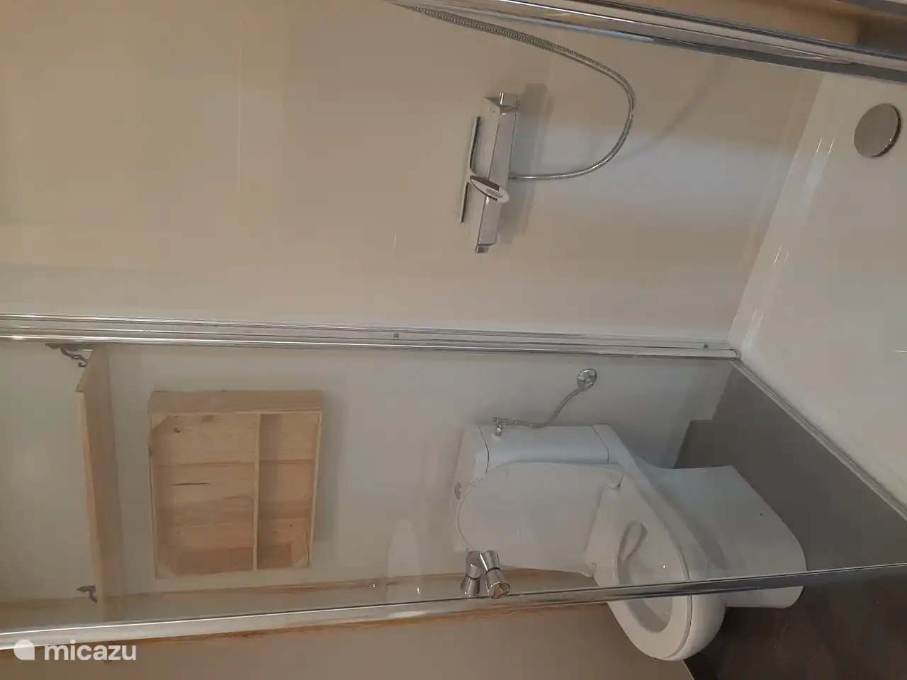 bathroom with shower, toilet and sink and hair dryer. There is a towel set per person