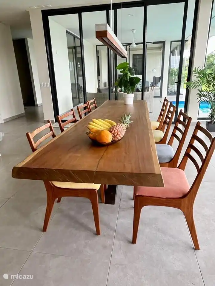 Dining table tropical hardwood with a view of the swimming pool