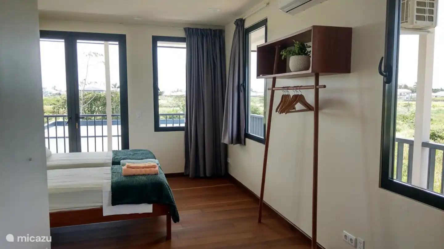 one of the additional three double bedrooms, each with its own bathroom. Beds and towels made.