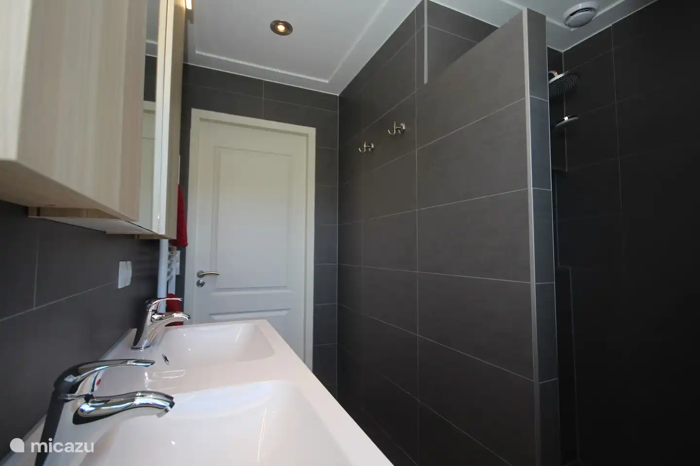 Salle de bain spacieuse avec chauffage au sol et sèche-serviettes.