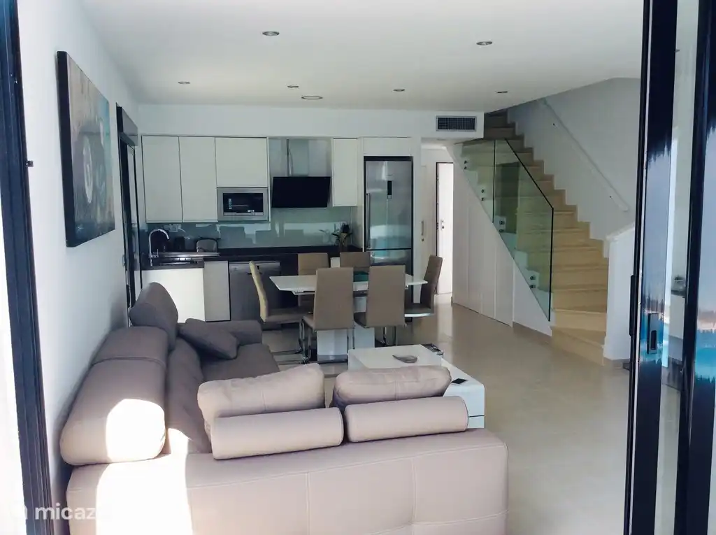 Living room with open equipped kitchen.