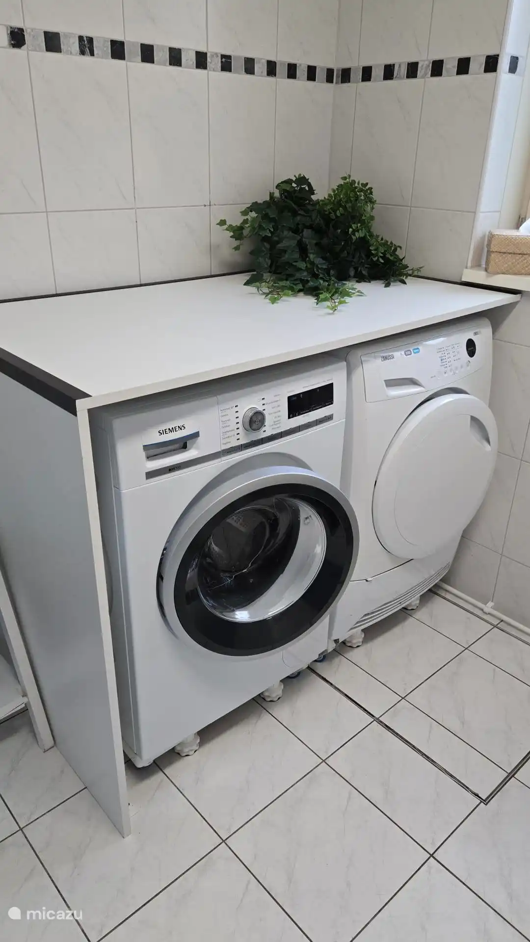 Washing machine and dryer in bathroom ground floor