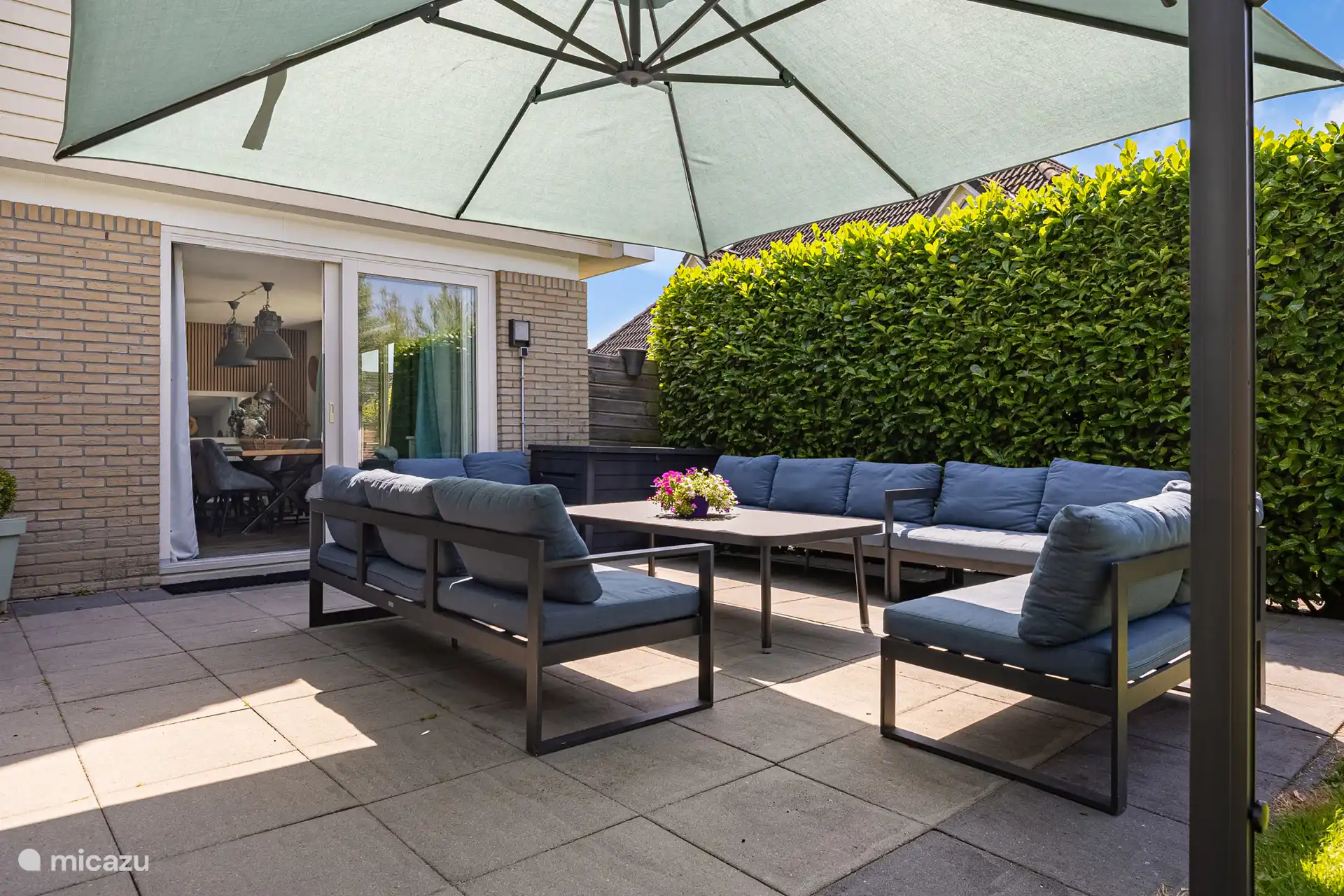 Spacious seating area with large parasol