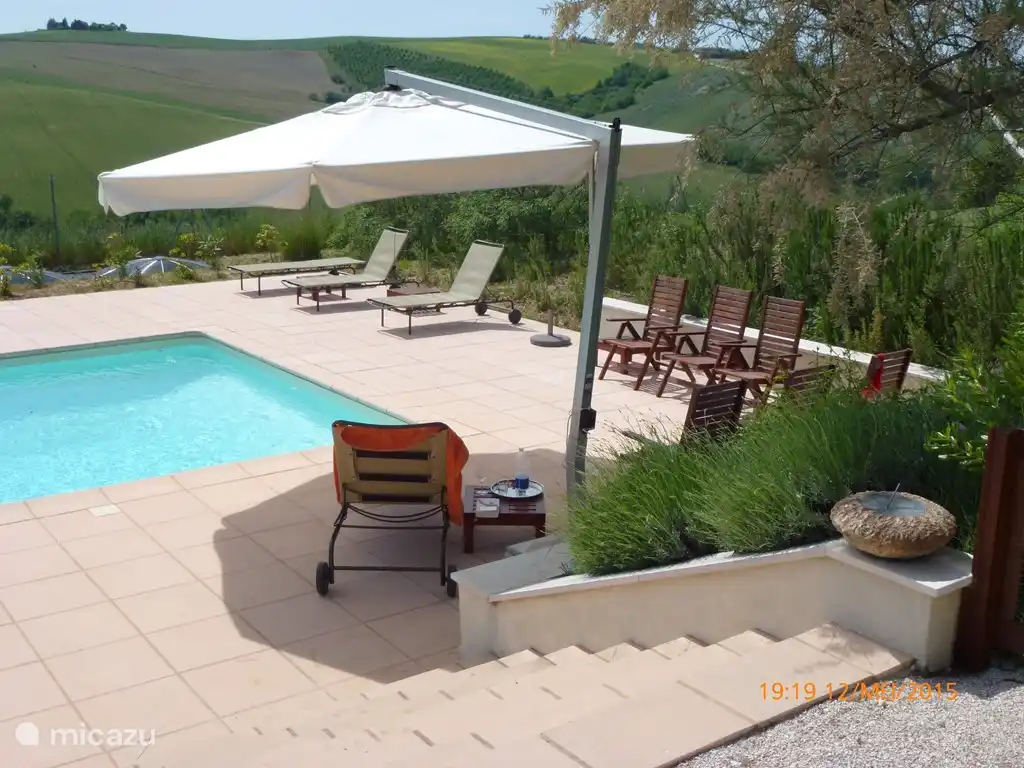 Zicht op het zwembad en de terrassen rond het bad