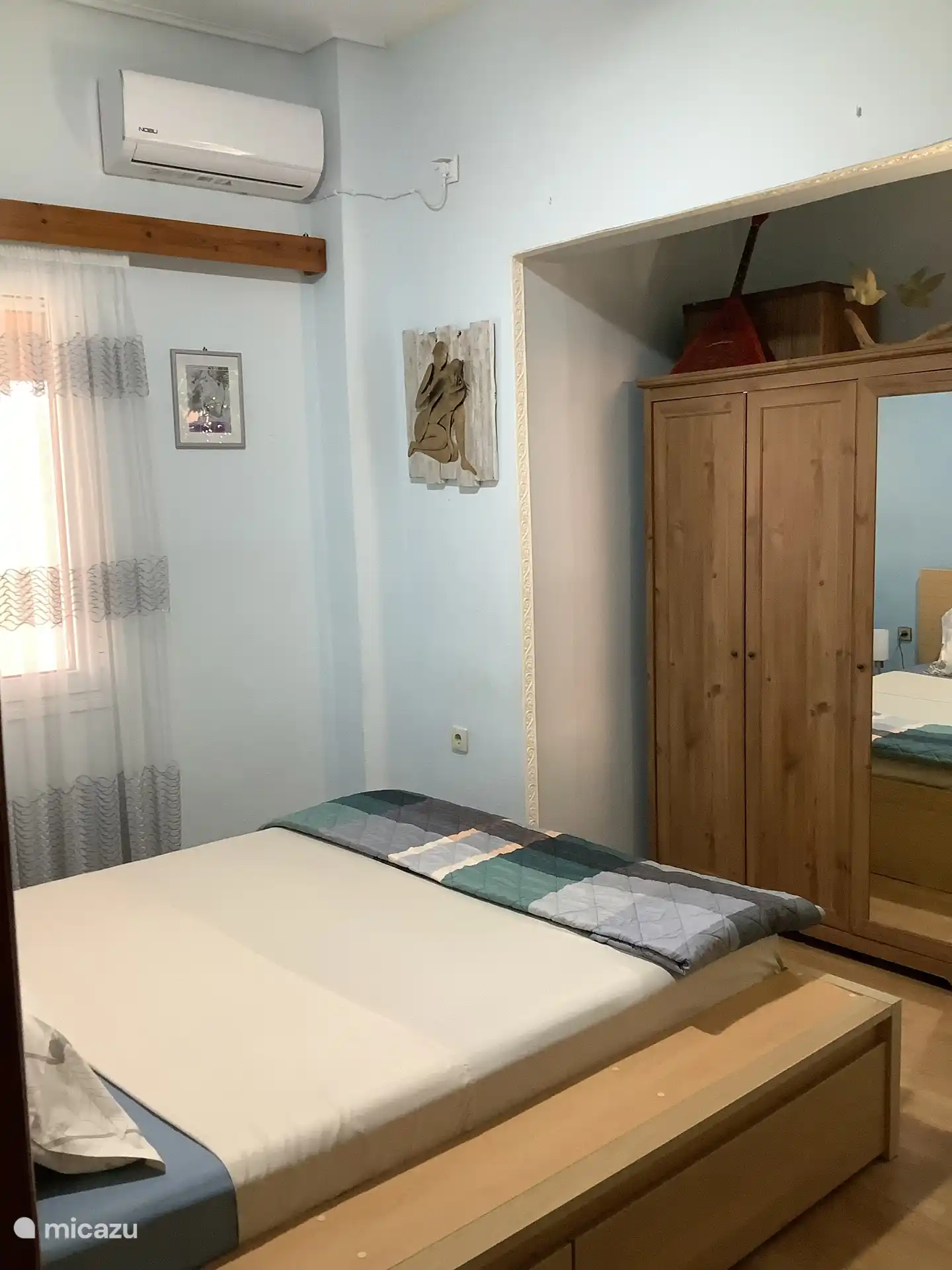 De slaapkamer met het twee persoons bed en de kledingkast