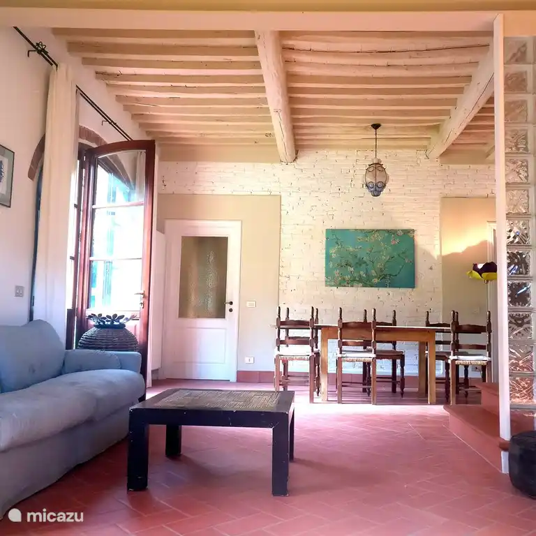 The dining/living room has three doors with French windows, facing West towards the garden and a private dining table area for the barn.  