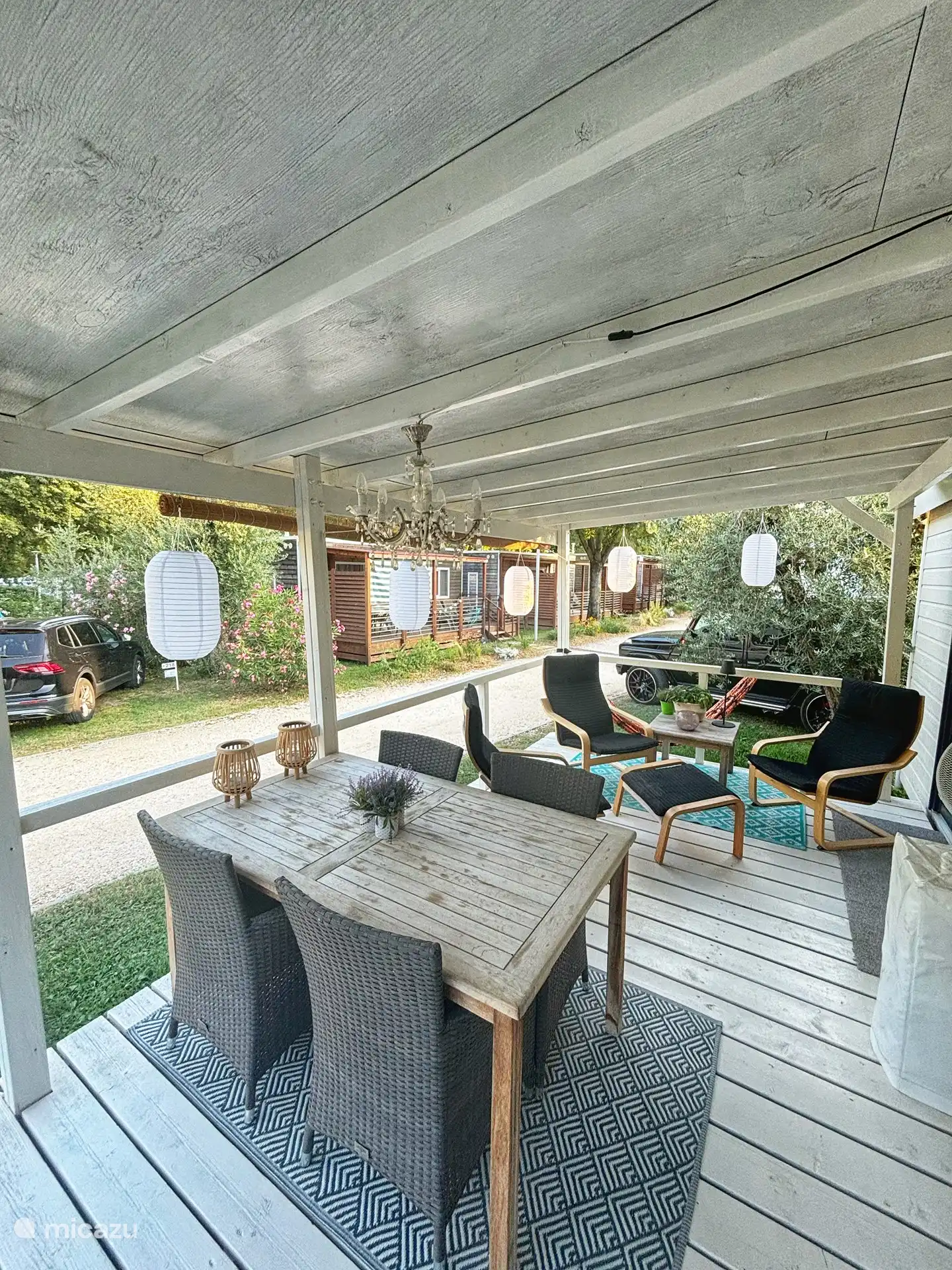 Grande terrasse couverte avec chaises longues et table à manger avec 4 chaises