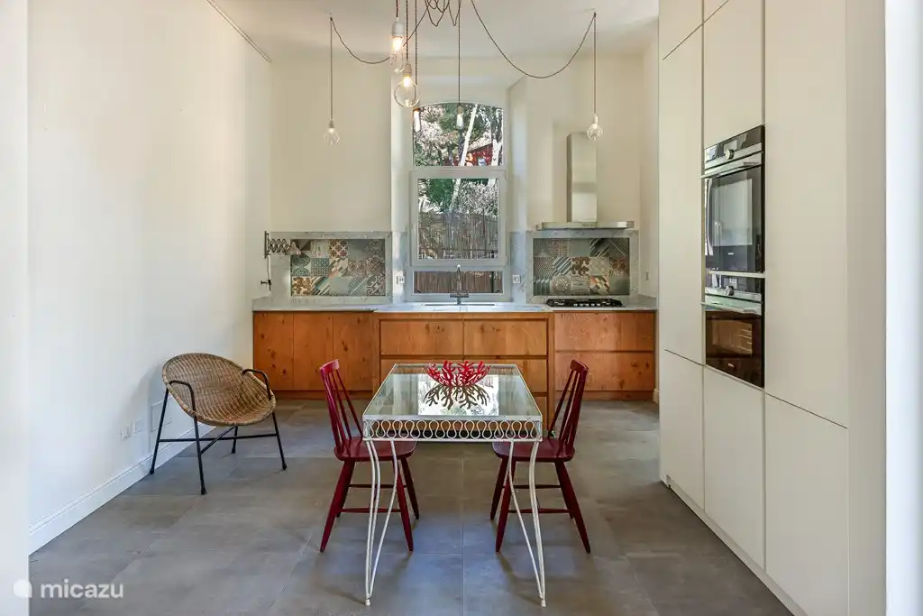 Comedor en la planta baja con cocina abierta con vapor y horno combinado.