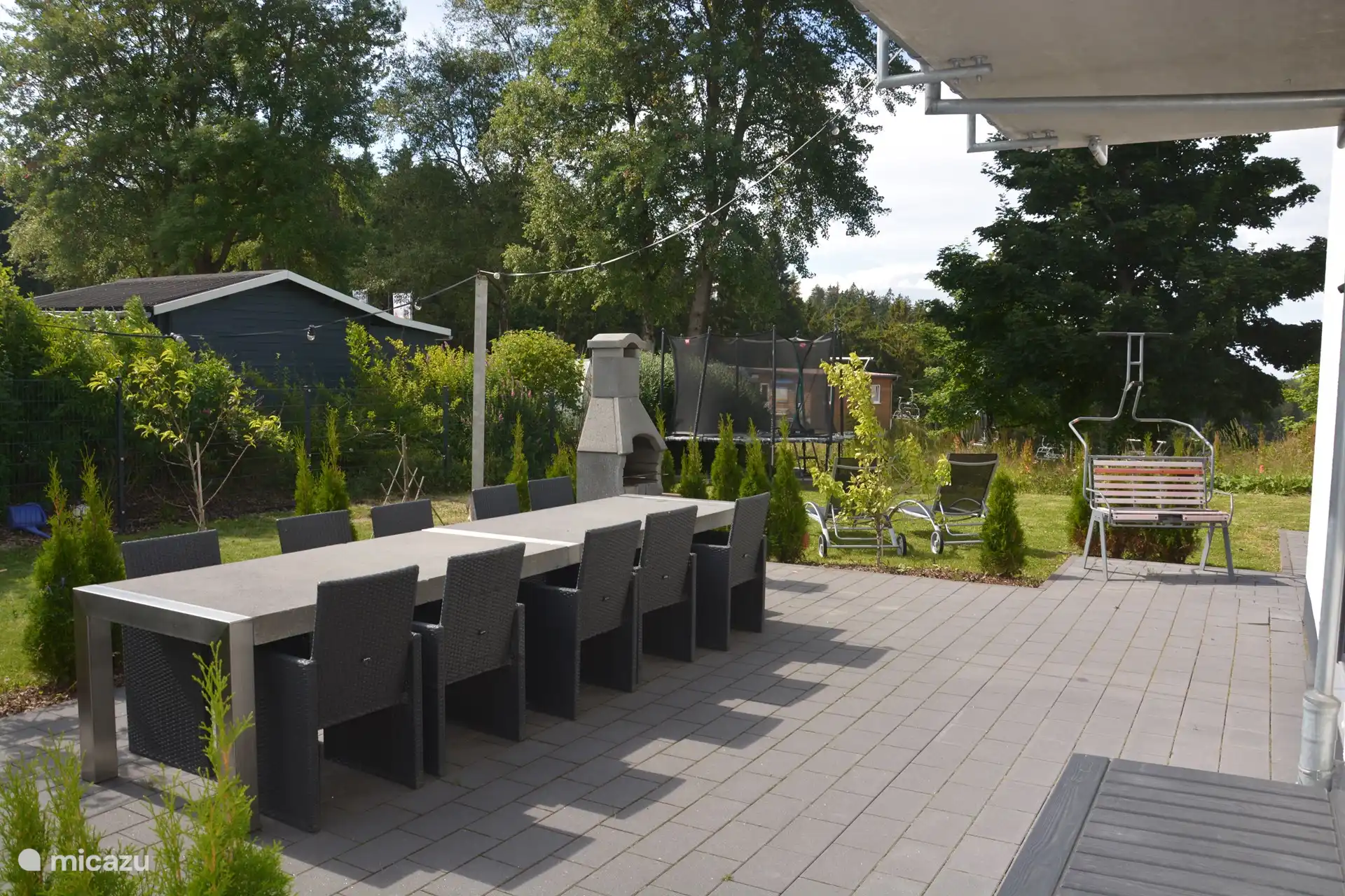 Nice outdoor dining with a group at a very large garden table.