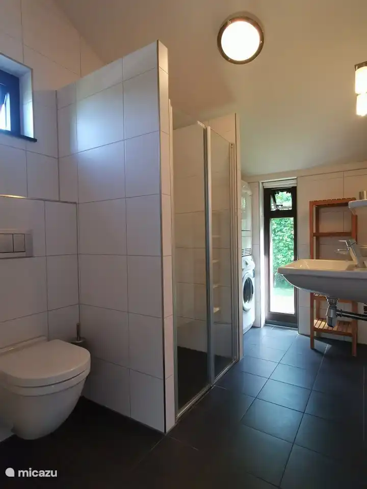 Badezimmer mit Waschbecken, Dusche und WC (auch Waschmaschine und Trockner)