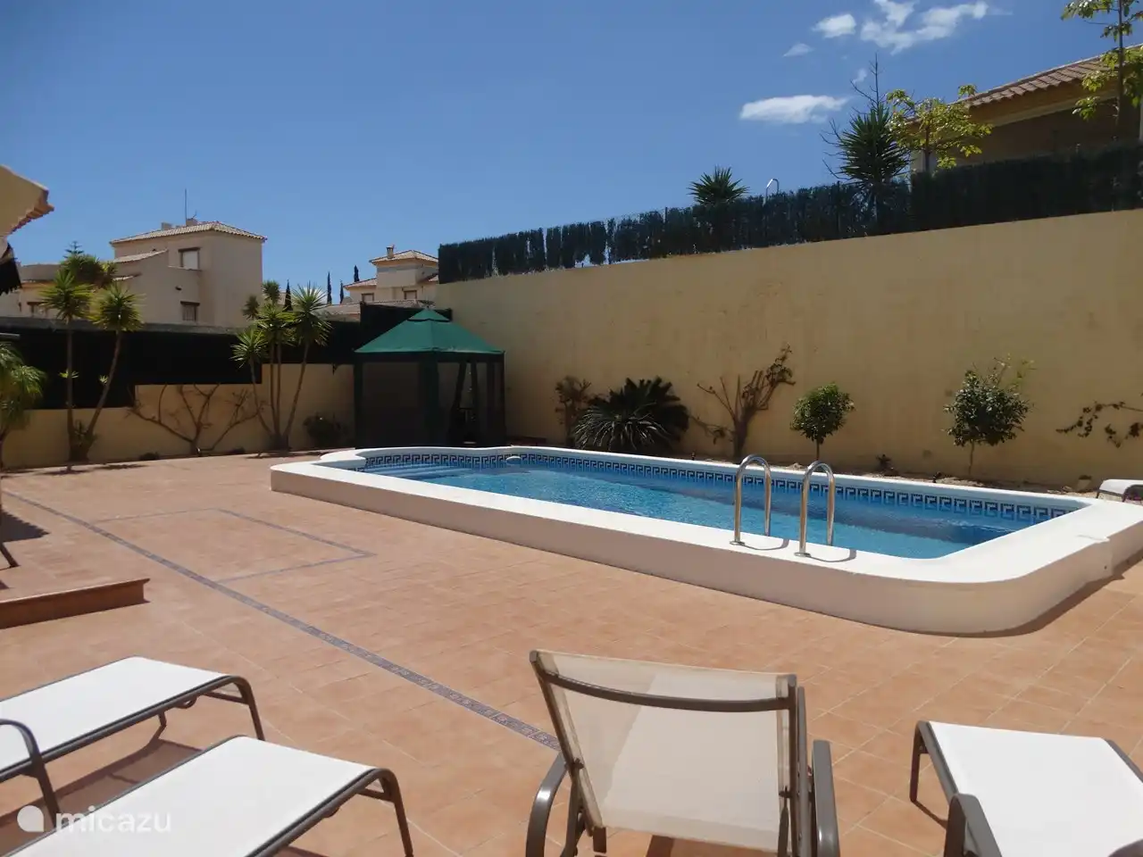 Private swimming pool with sun loungers