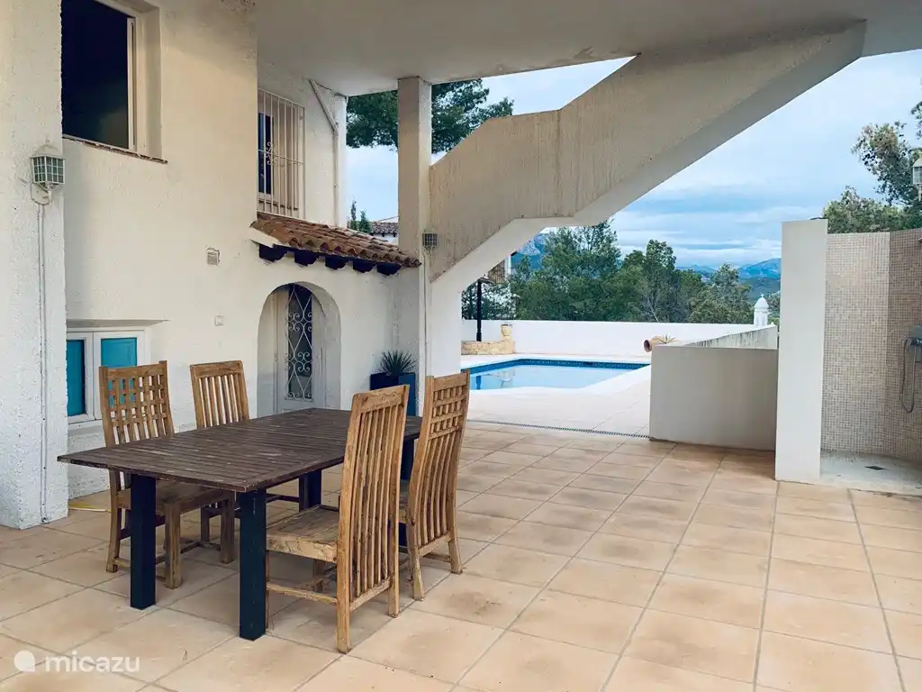 Shaded terrace with access to El Cueva, swimming pool and outdoor shower.