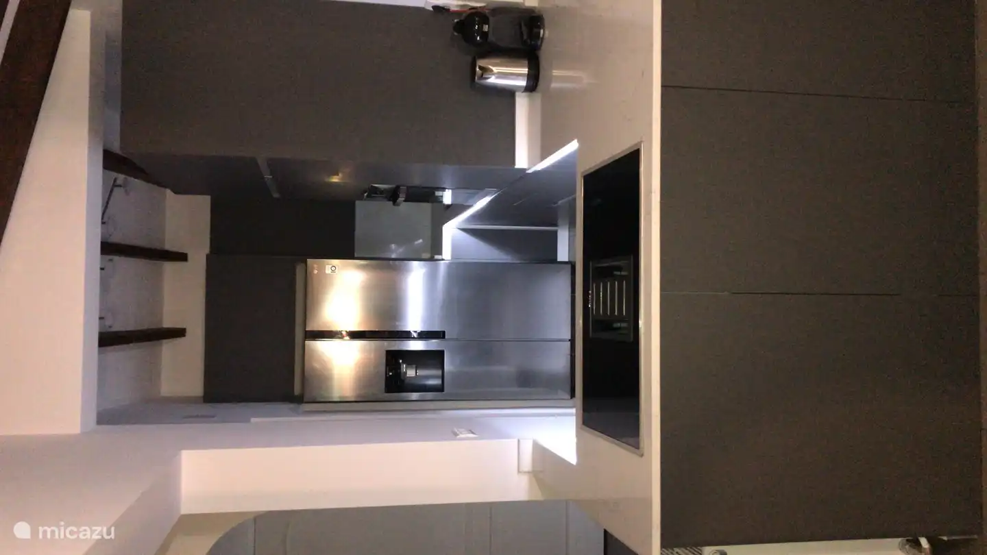 Modern kitchen with large American fridge with ice cube dispenser