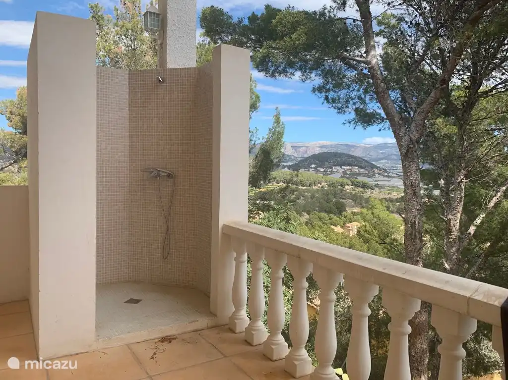 Outdoor shower with hot water on the ground floor with a sea view.