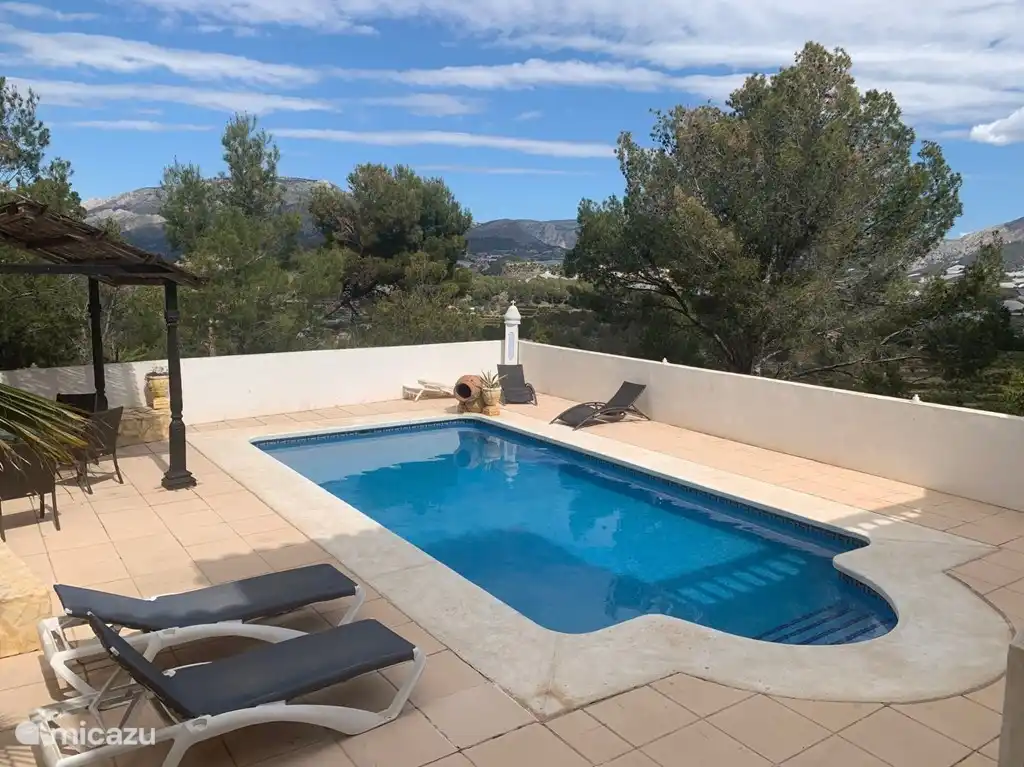swimming pool with panoramic view, sun terraces with sun beds.