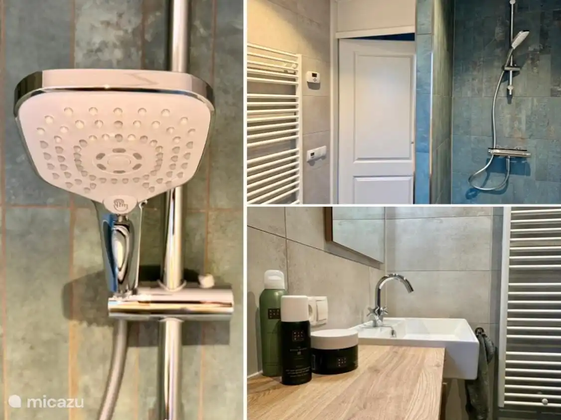 Das Badezimmer verfügt über Fußbodenheizung und verfügt über eine Dusche und ein Waschbecken.