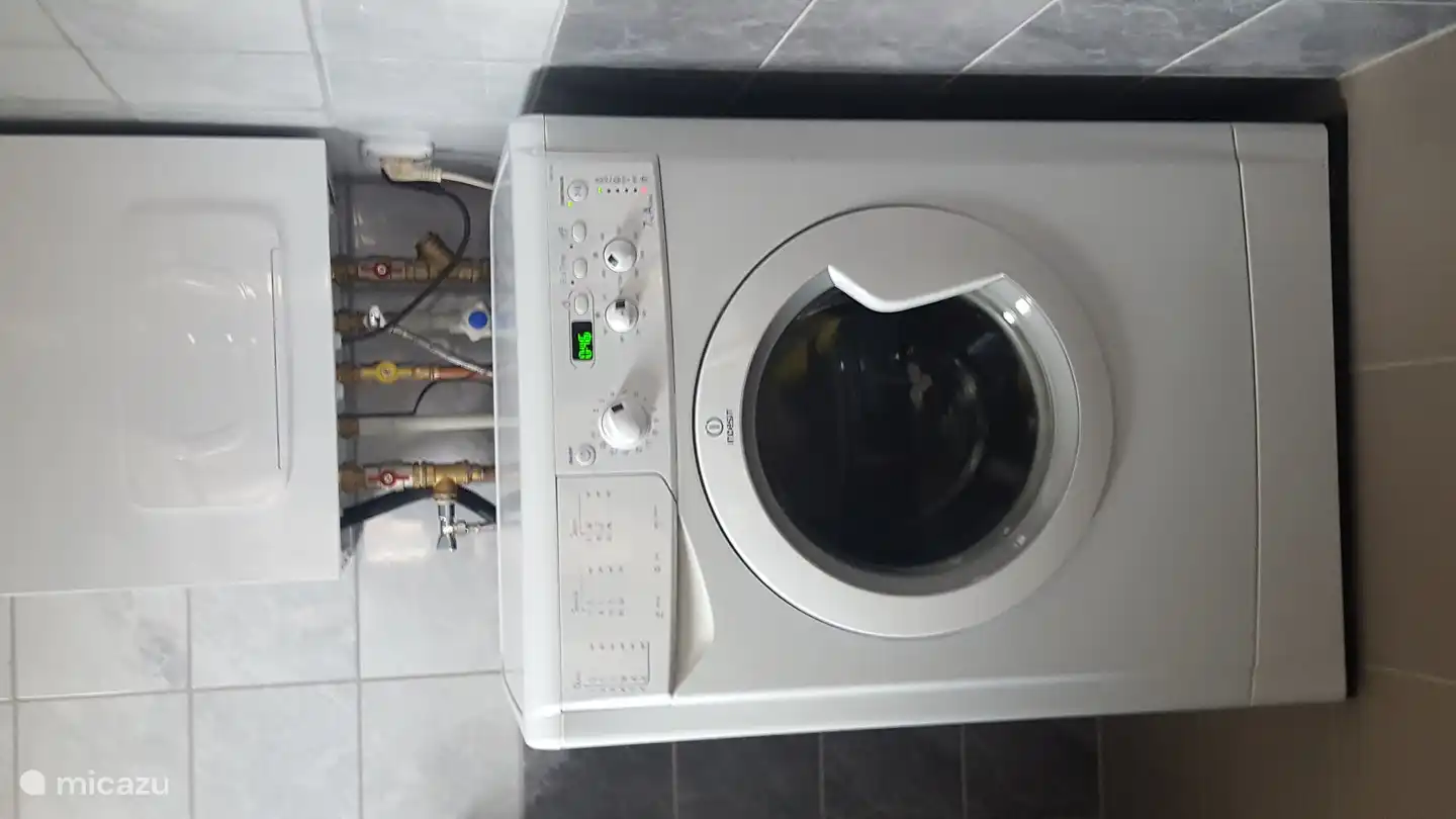 Washing machine with above the combi-boiler for heating and hot water