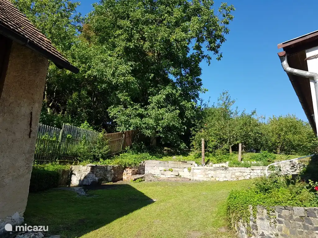 garden with left the stone barn and right the house
