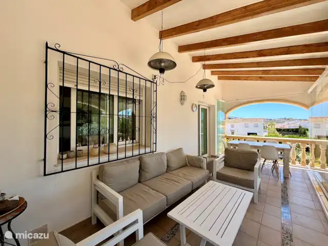 Location de Vacances Espagne, Costa Blanca, Benitachell, villa - Les Fonts Benitachell, Alicante Lanai avec table pour 6 personnes et coin salon. La véranda a une paroi vitrée rétractable