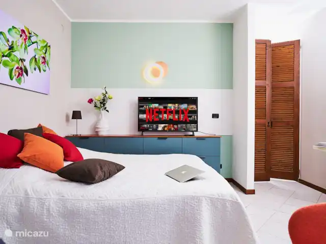 Le Quattro Stagioni Lakeview-beach huren in Italië, Comomeer, Acquaseria - appartement Romantische living welke stijlvol en warm is ingericht . Queen-size bed met uitzicht over het meer. Screens aan de buitenkant van de brede balkondeuren.