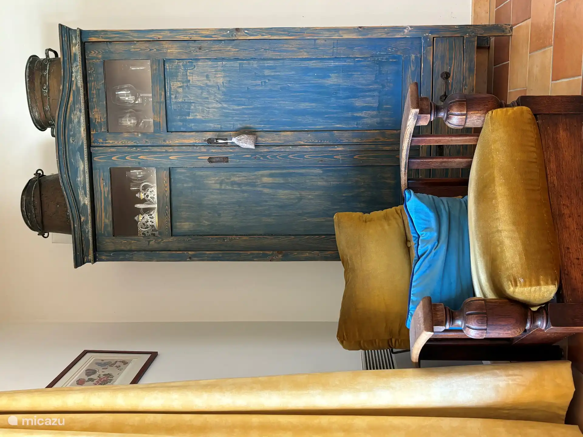 Ein antiker Stuhl und ein antiker blauer Schrank mit Spielen