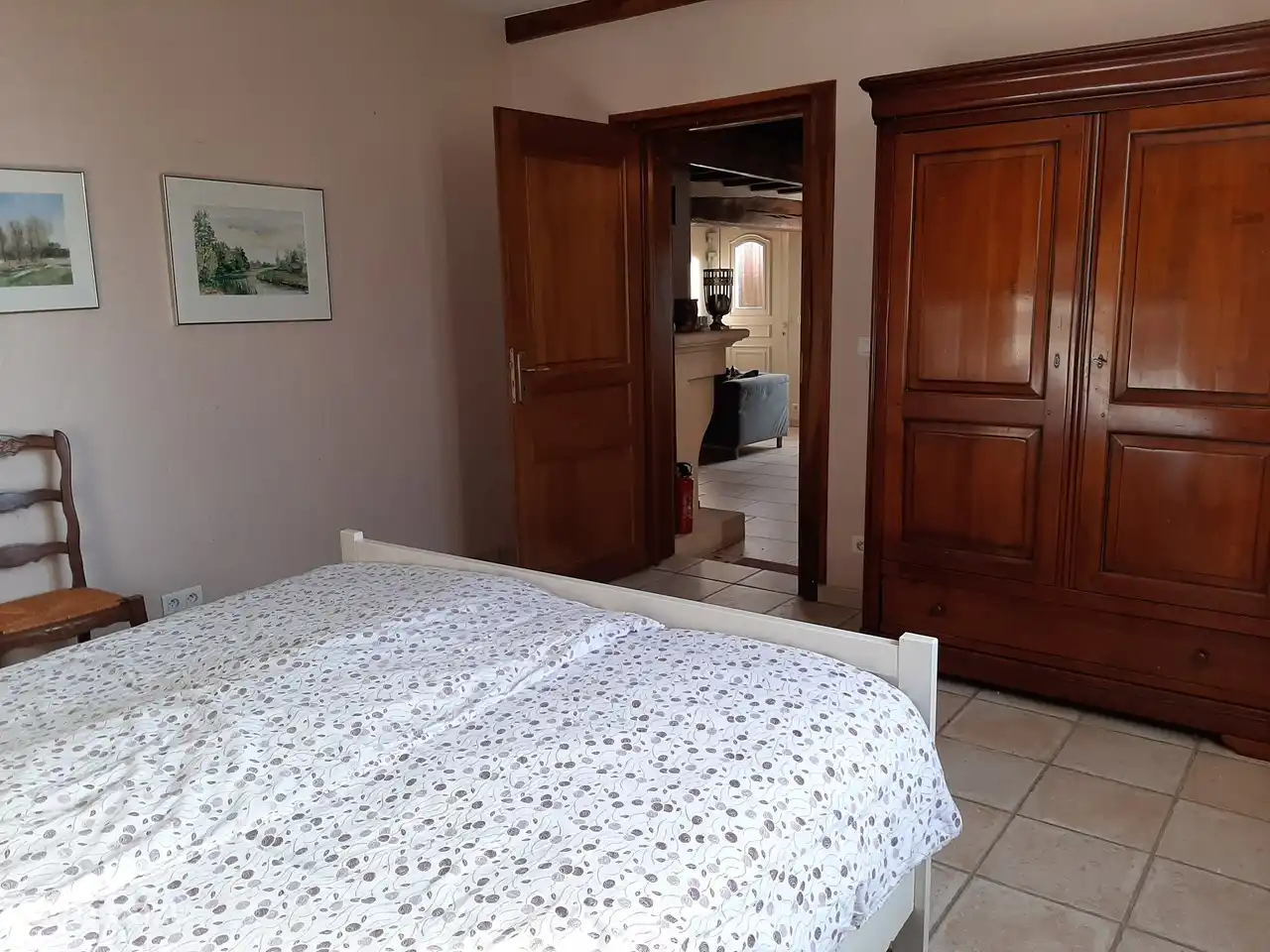 The bedroom on the ground floor with a view of the living room.