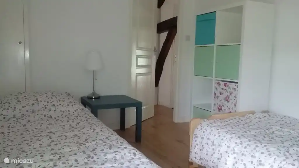 The bedroom with 2 single beds on the floor.