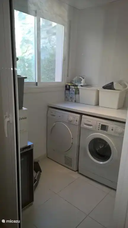 Storage room with washing machine, dryer, wine cooler and freezer
