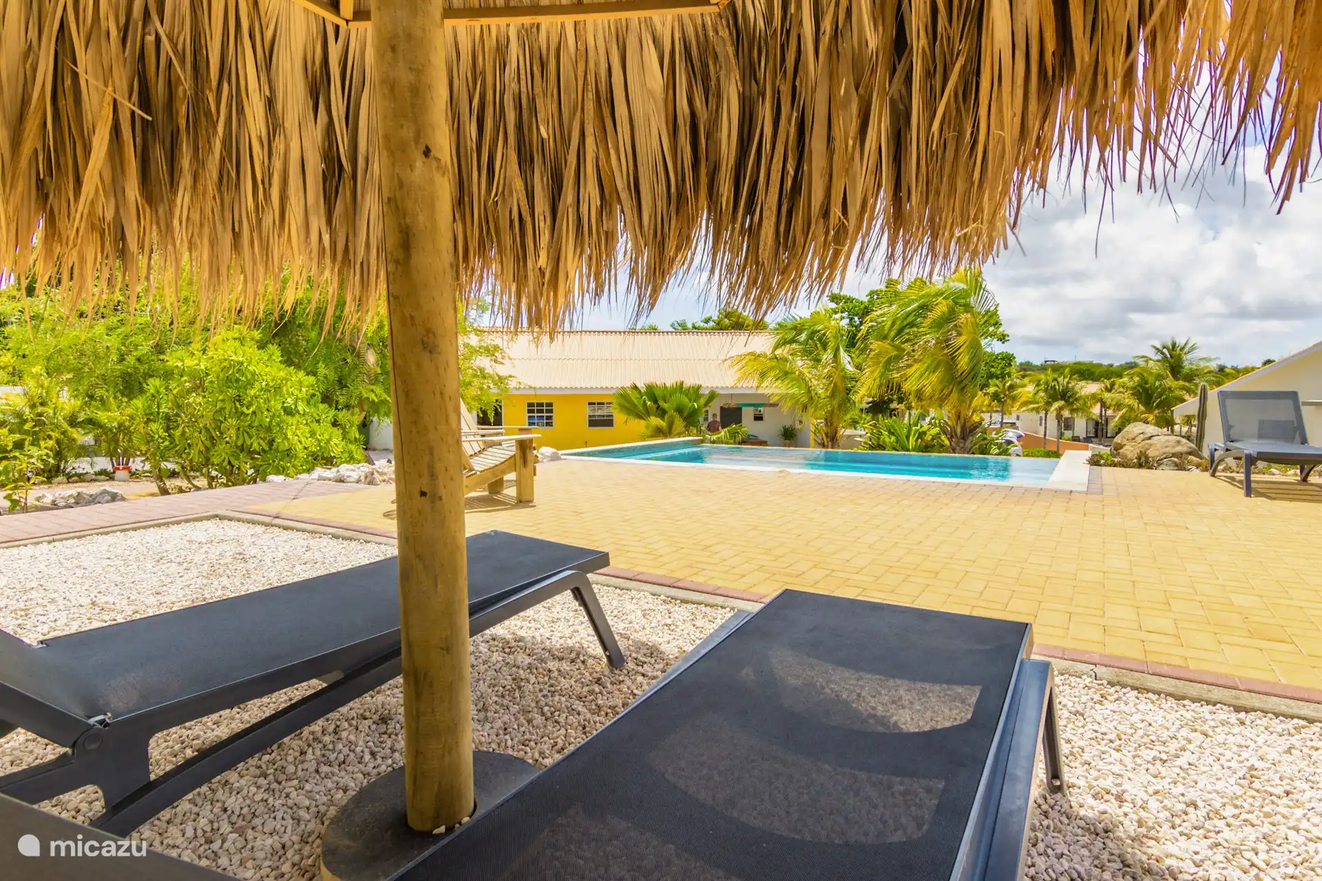 Enjoy a lounger under the palapa