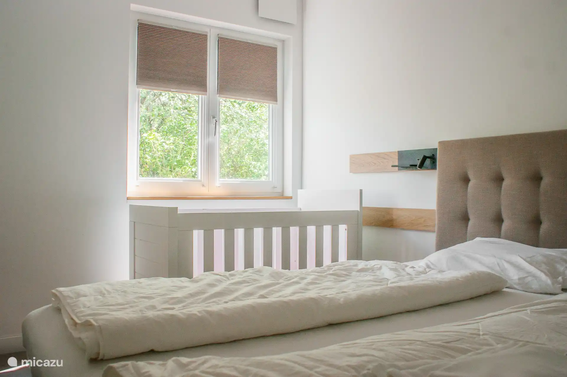 Three spacious bedrooms, one with a cot. Each bedroom has its own sink.