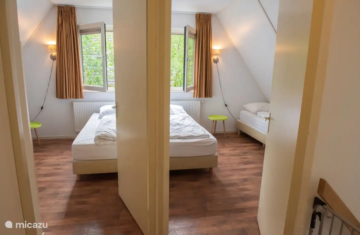 Two (children's) bedrooms with two separate beds each.