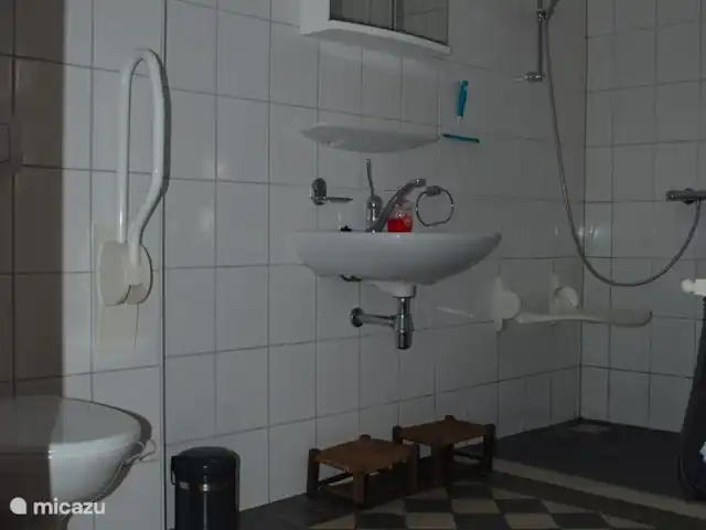 Au Westhoek | Pays-Bas, Zélande, Koudekerke - maison de vacances Salle de bain spacieuse, accessible aux fauteuils roulants, avec douche à l'italienne avec chaise de douche, lavabo et deuxième toilette avec barres d'appui.