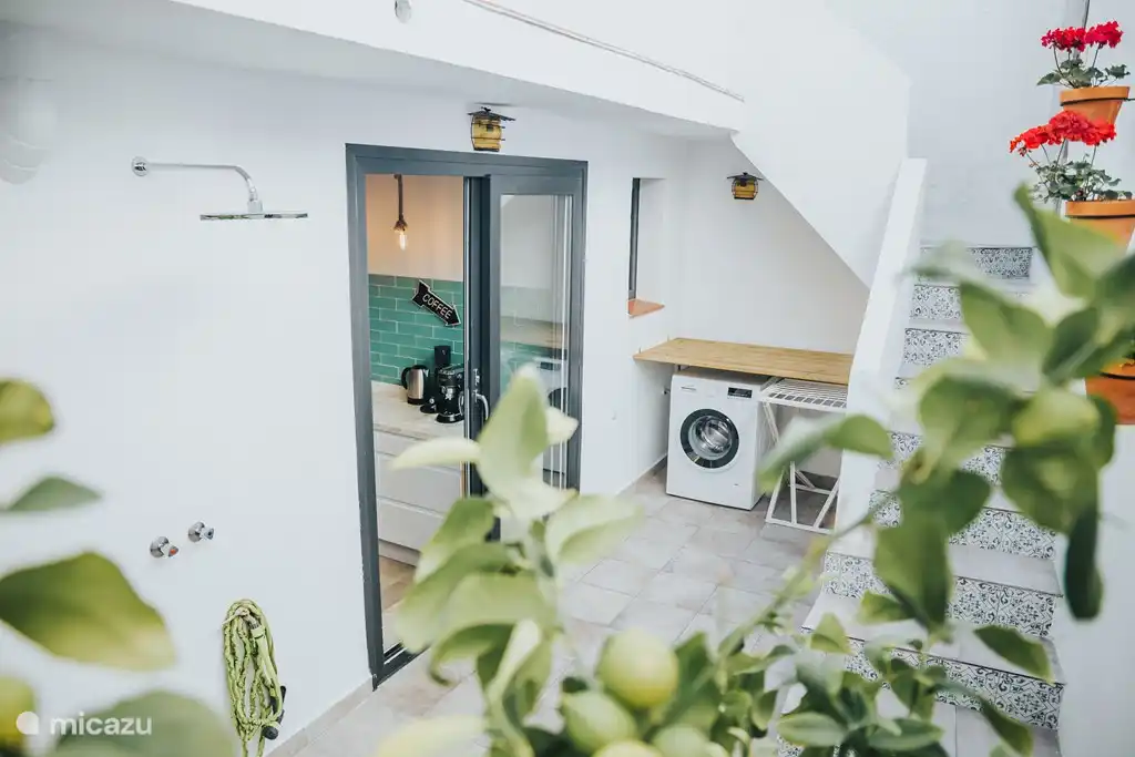 Outdoor (warm) shower, washing machine & dryer in patio