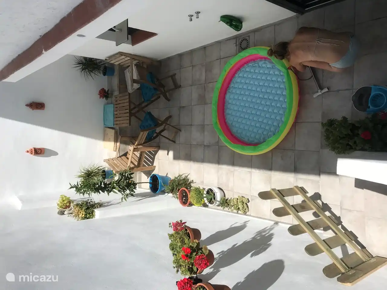 The patio with a cosy sit area, warm outdoor shower and space for the pool for the little ones.