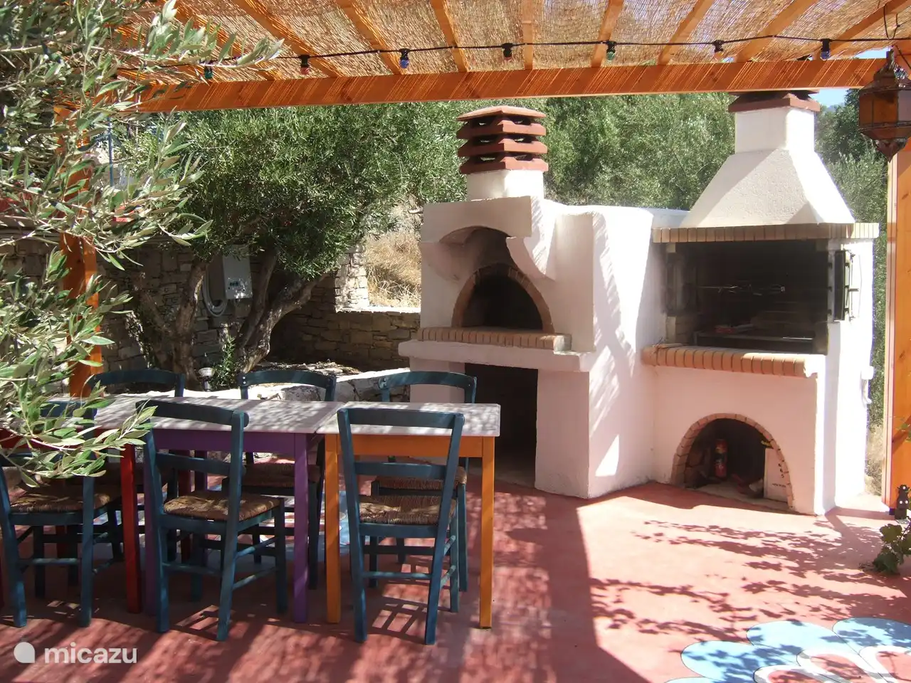 Shady terrace with BBQ and pizza oven.