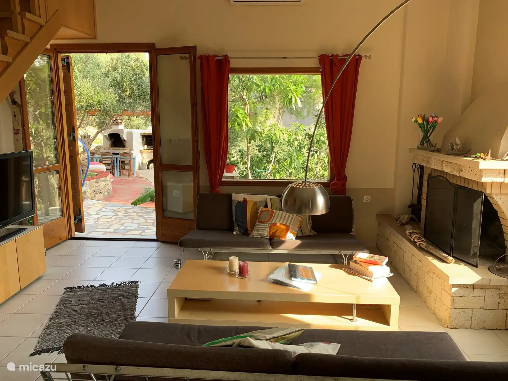 The spacious living room with a view to the BBQ terrace.