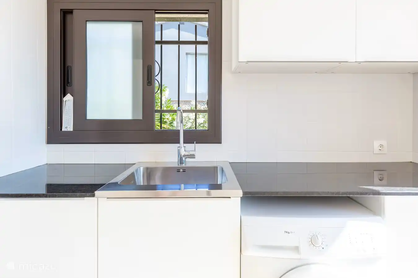 Utility room with washing machine and walk-in shower