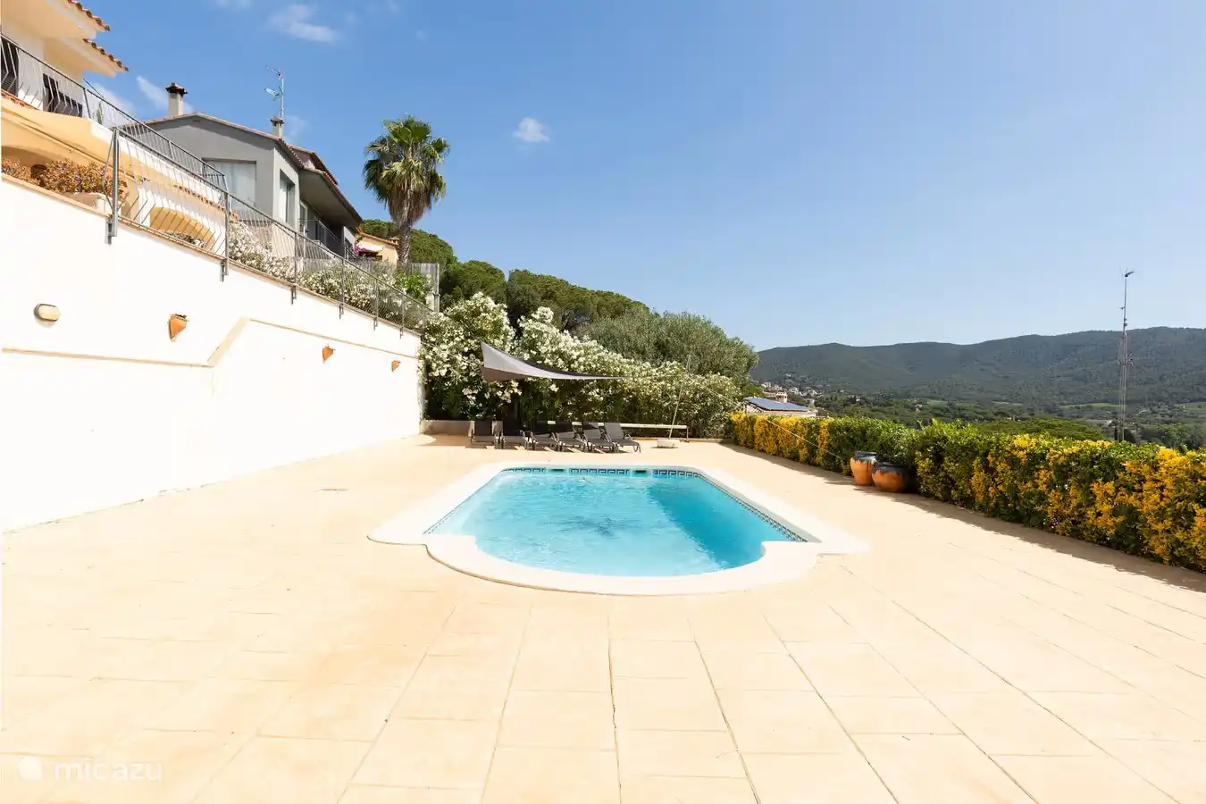 Swimming pool sun terrace with sunbeds