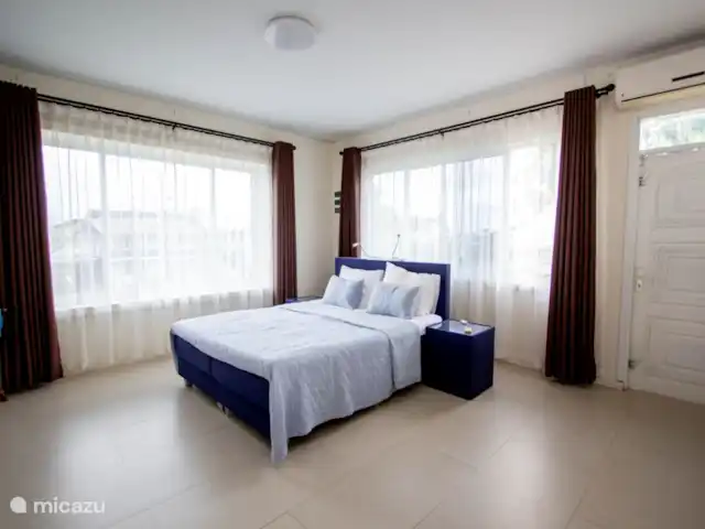 Location de Vacances Suriname, Paramaribo, Paramaribo, appartement - Kamra B - Oso Josich Chambre principale (chambre 1) avec un lit double et de grandes armoires et salle de bain privée