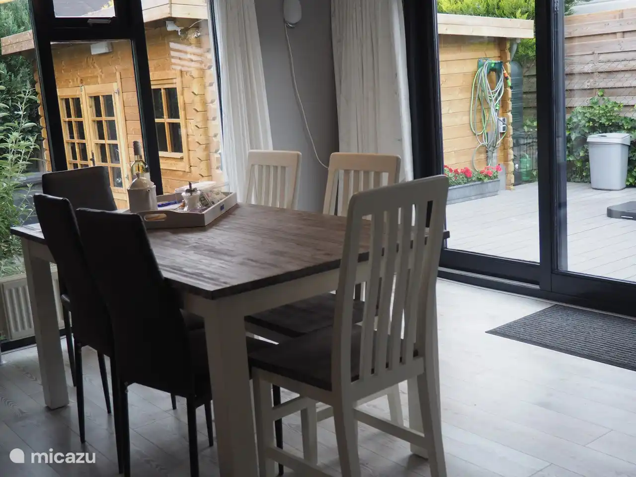 Table à manger 6 places devant les portes coulissantes donnant sur la terrasse.